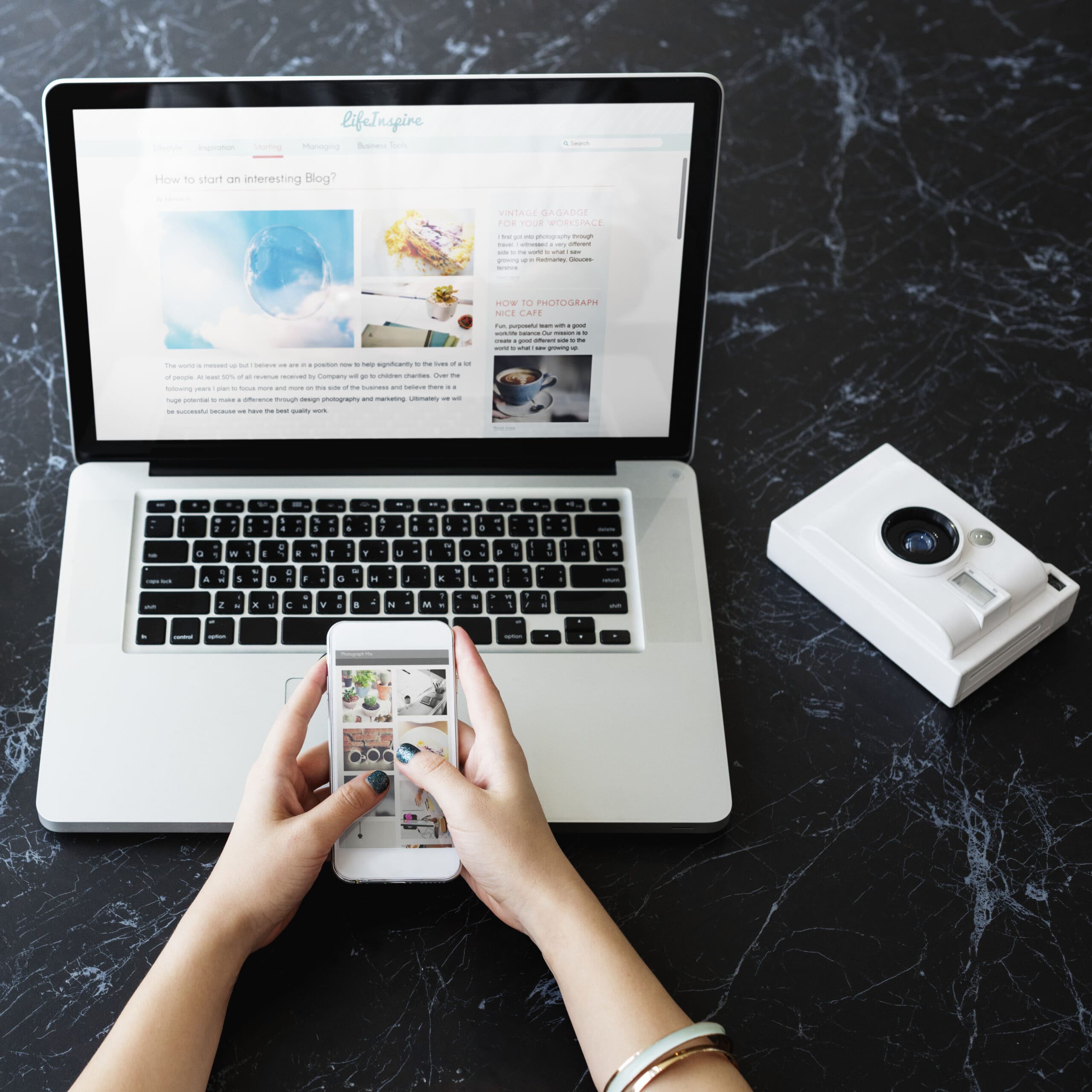closeup-hands-using-mobile-phone-computer-laptop-black-marble-table